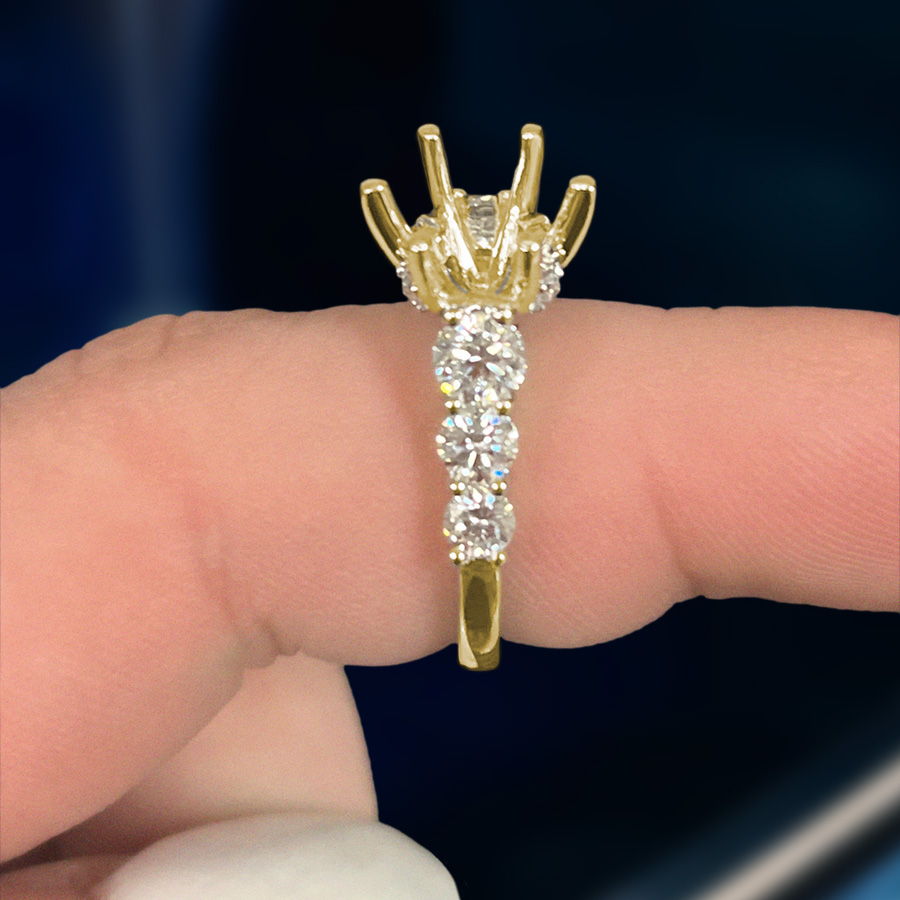 A custom diamond engagement ring setting in yellow gold