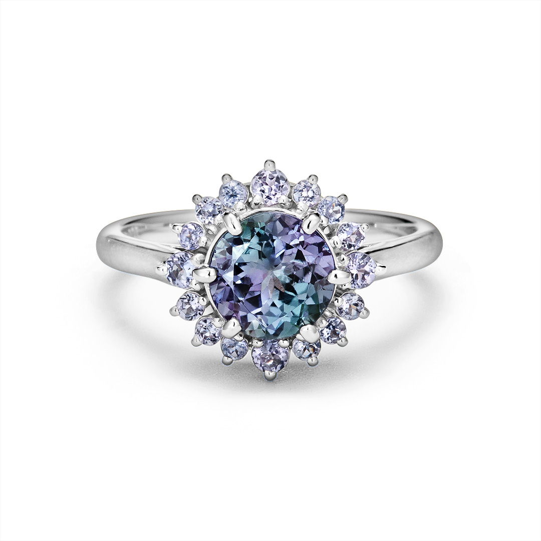 A silver ring featuring a blue and purple gemstone surrounded by smaller stones.