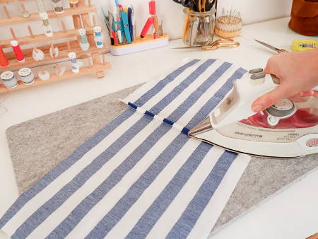 two pieces of fabric sewn together and ironed on a wool pressing mat