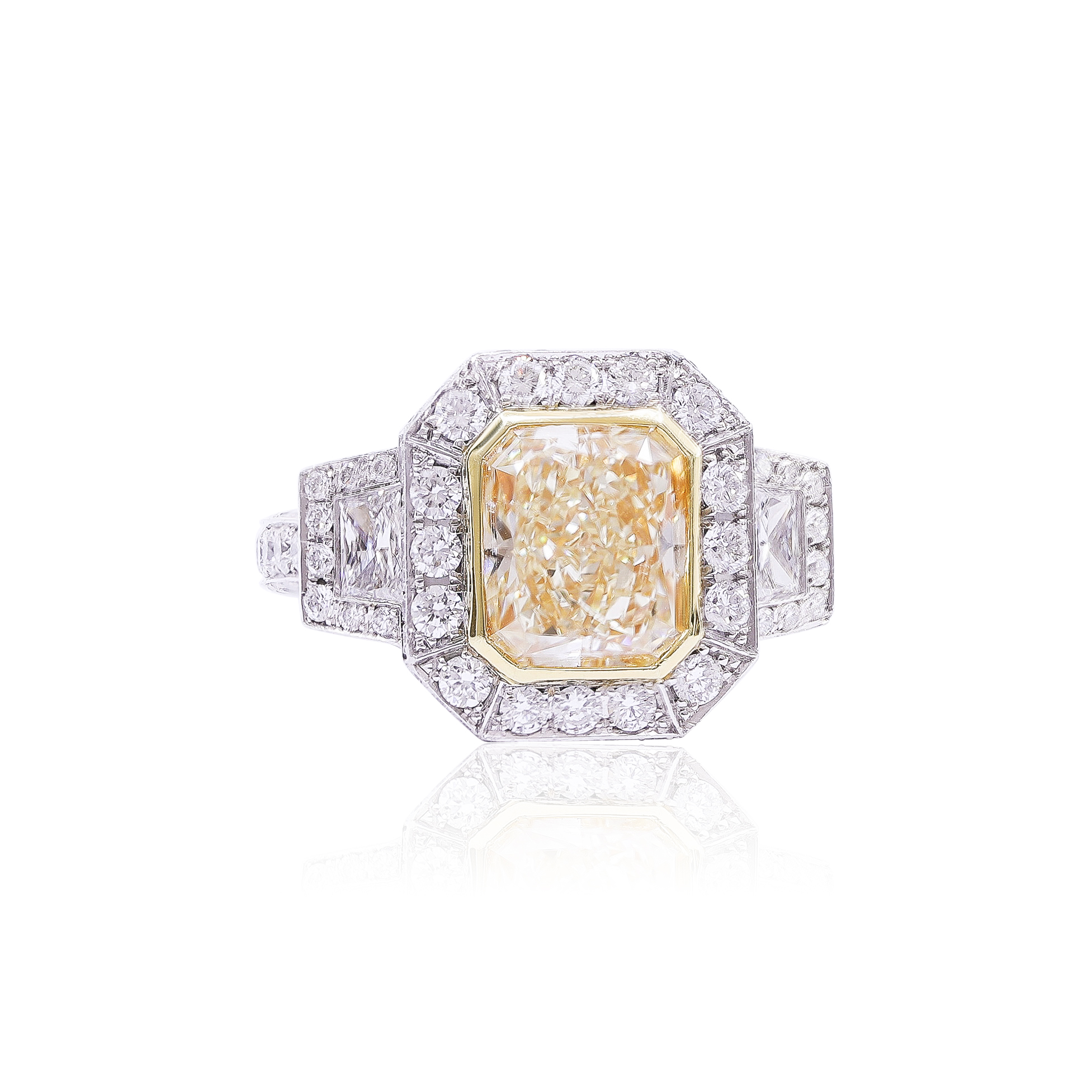 Platinum three-stone diamond ring with a fancy yellow radiant center diamond