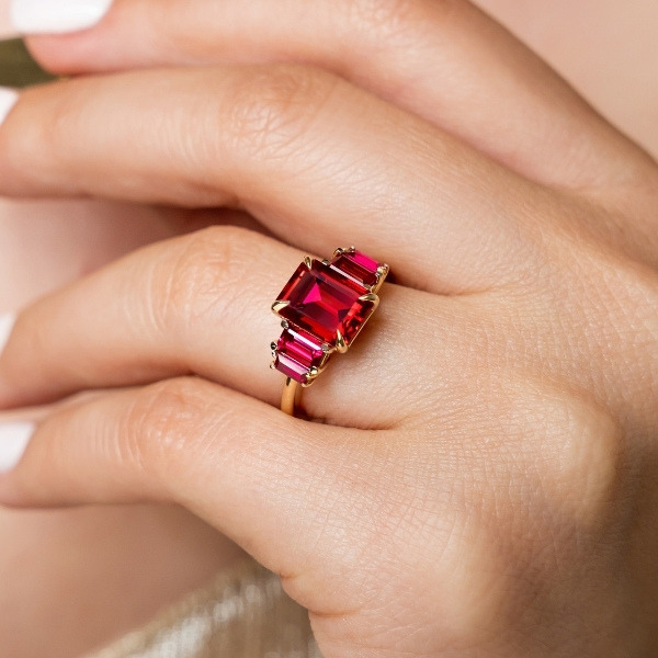 custom designed ruby engagement ring with two multi-tired ruby side stones on either side for a total of 5 stones