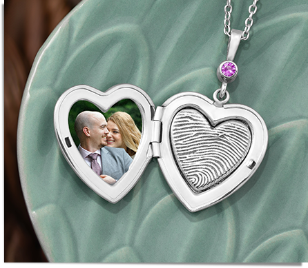 sterling silver locket in the shape of a heart engraved with a fingerprint