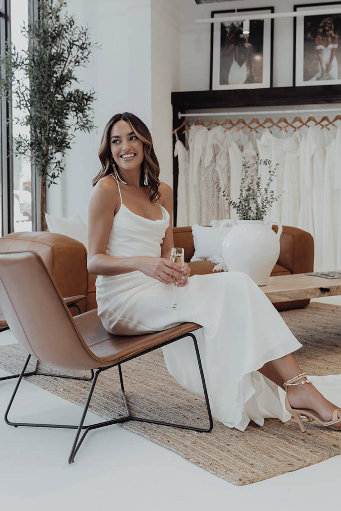 Bride wearing the Honey Silk gown Inside the Grace Loves Lace Miami bridal showroom
