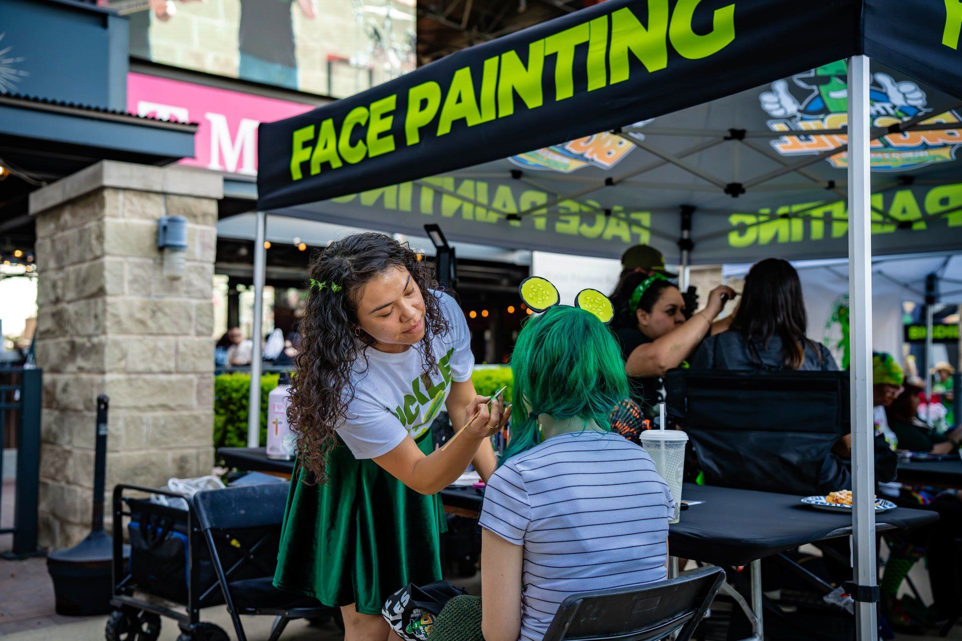 Free face painting, a complimentary amenity offered at every Big Dill festival, at The Big Dill pickle festival, Globe Life Field and Texas Live!, Arlington Texas 2025.