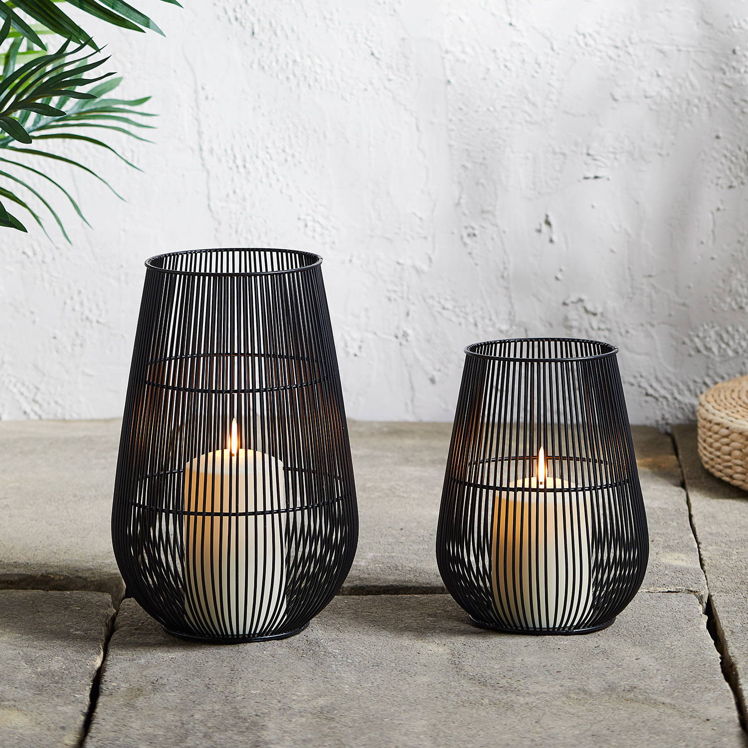 Melbourne lantern duo sat on patio and illuminated 