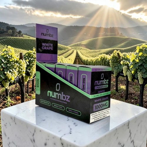 Box of Numbz products in a vineyard setting with mountains and sunlight.