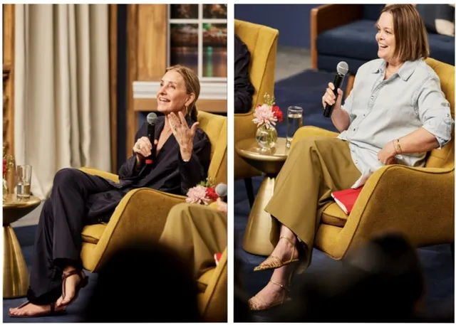 Two women seated in armchairs during a discussion, engaged in conversation.