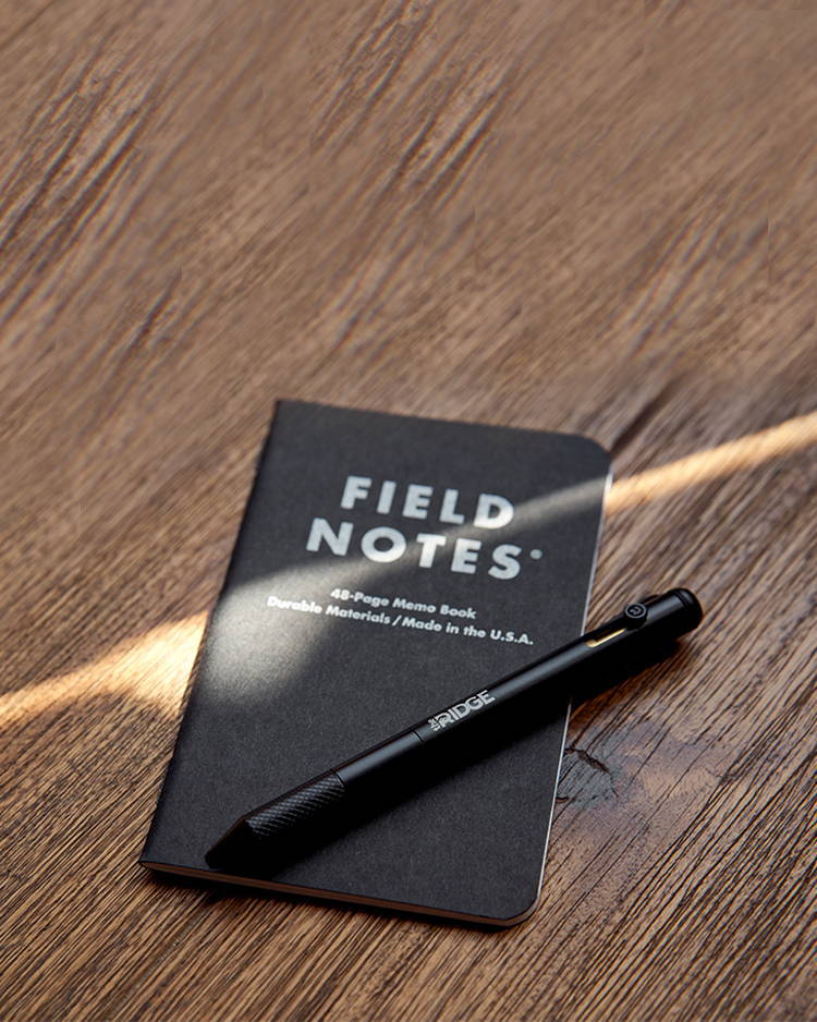Matte Black Titanium Bolt Action Pen and Ridge Field Notes on wooden top