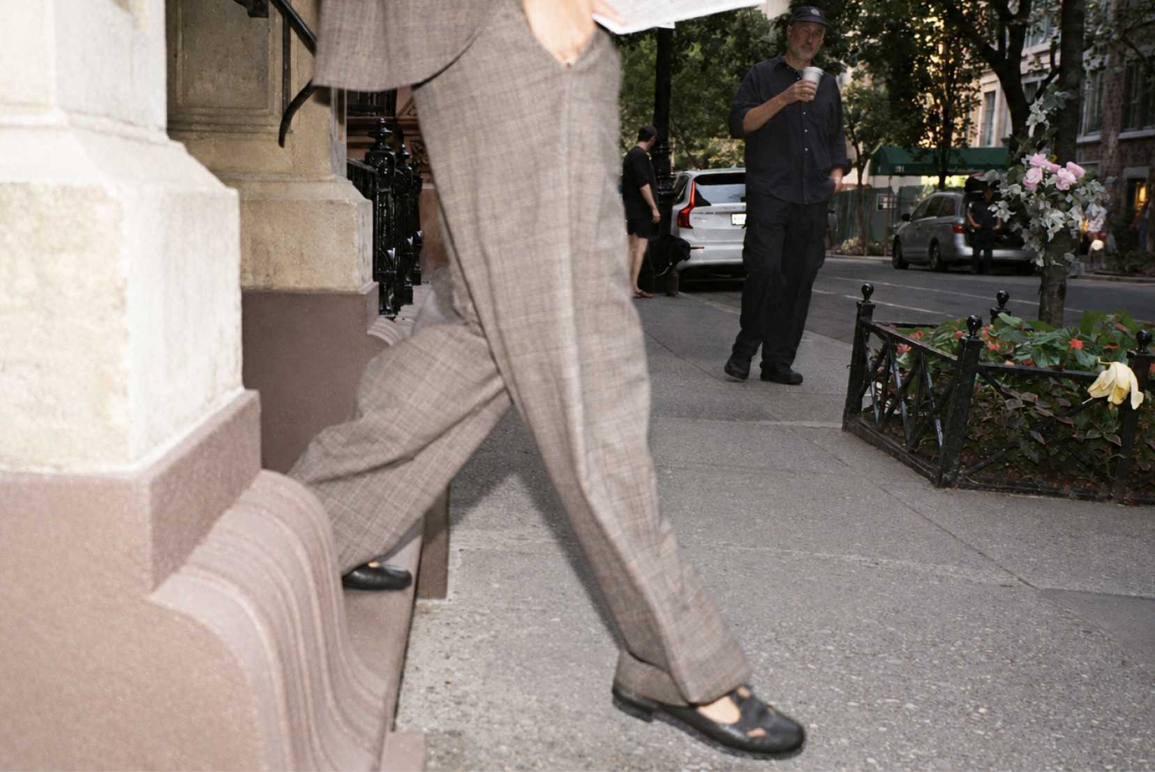 women's legs stepping onto sidewalk