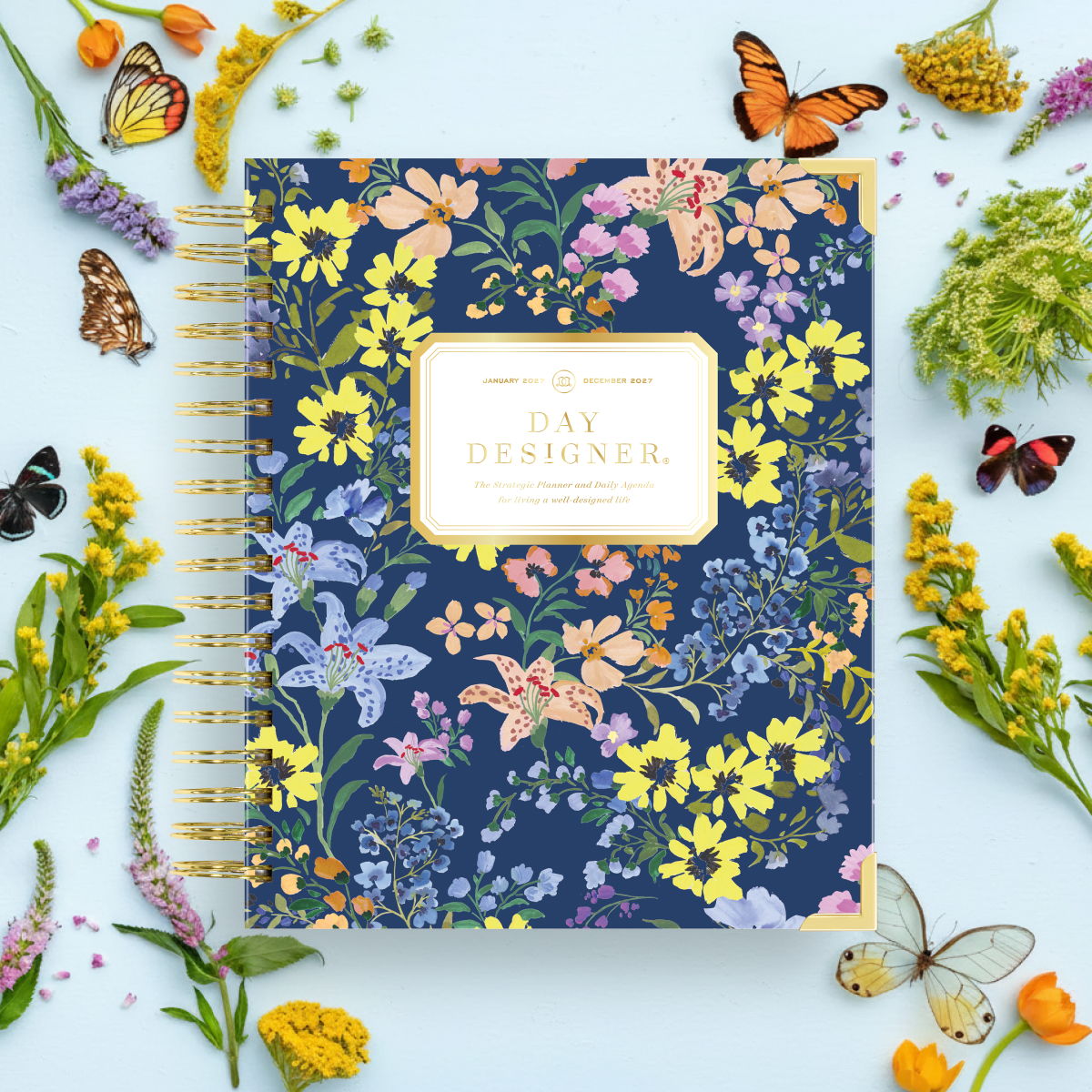 2027 day designer planner featuring assorted flowers on a navy blue background