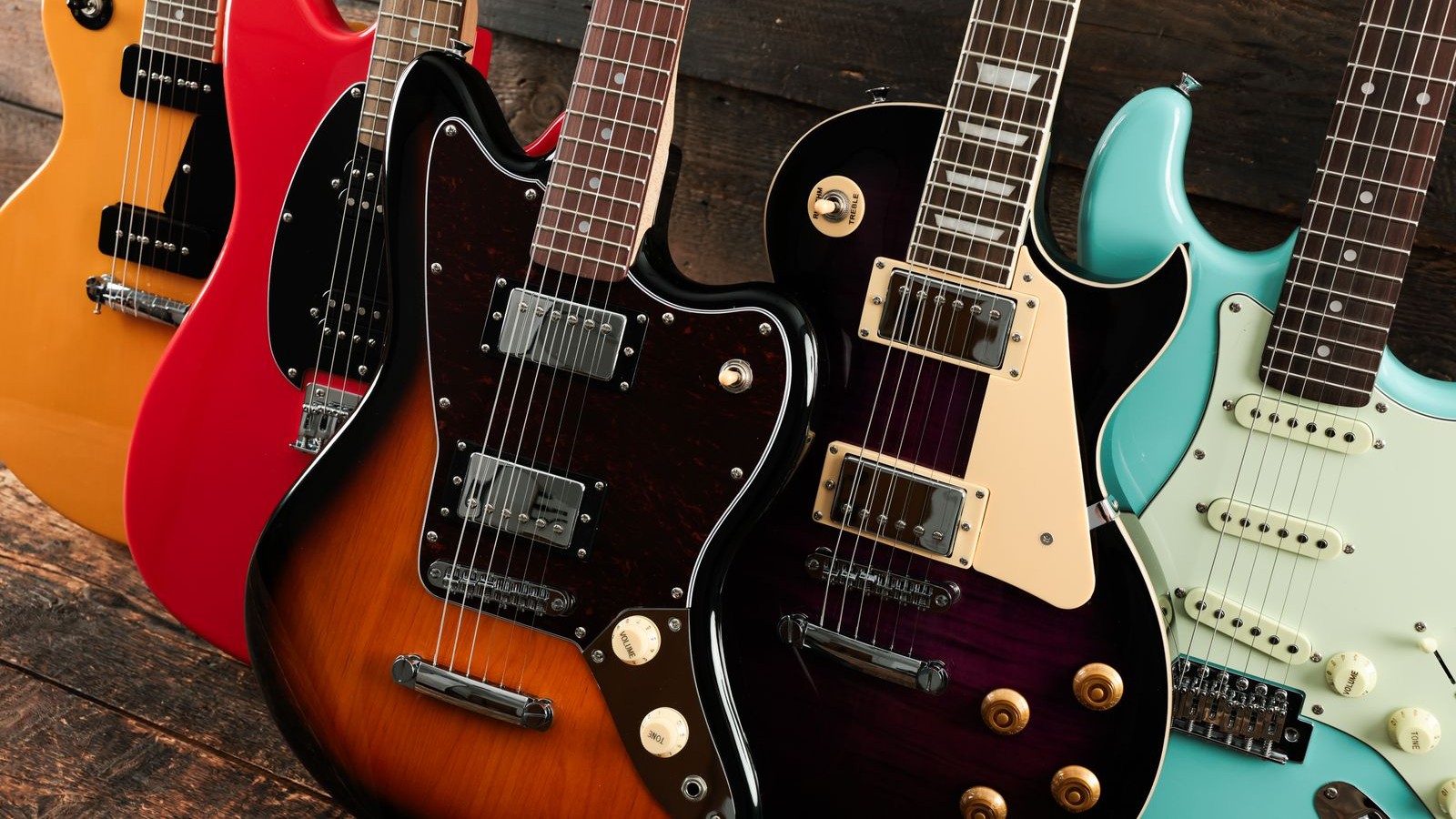 A collection of colorful electric guitars arranged together.