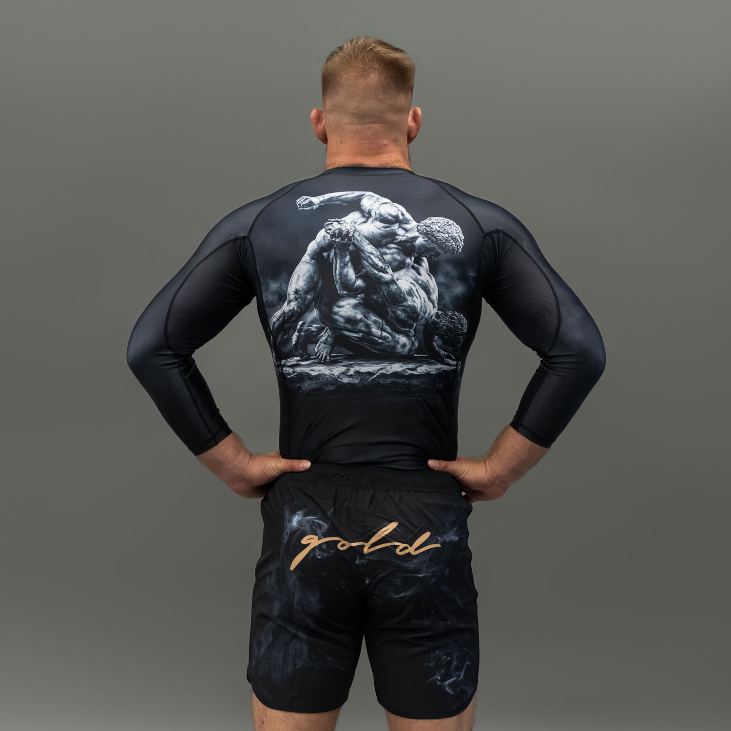 Person wearing a black athletic outfit with a graphic design on the back.