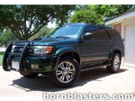 Front three-quarter dark green Toyota 4Runner black brush guard chrome wheels driveway Shocker XL train horn featured customer install gallery photo 1
