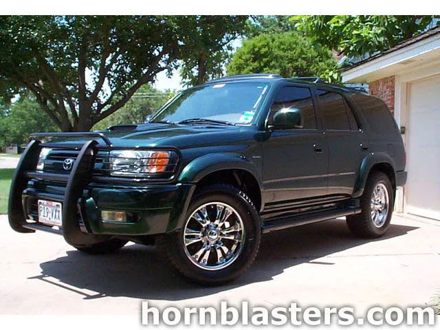 Front three-quarter dark green Toyota 4Runner black brush guard chrome wheels driveway Shocker XL train horn featured customer install gallery photo 1