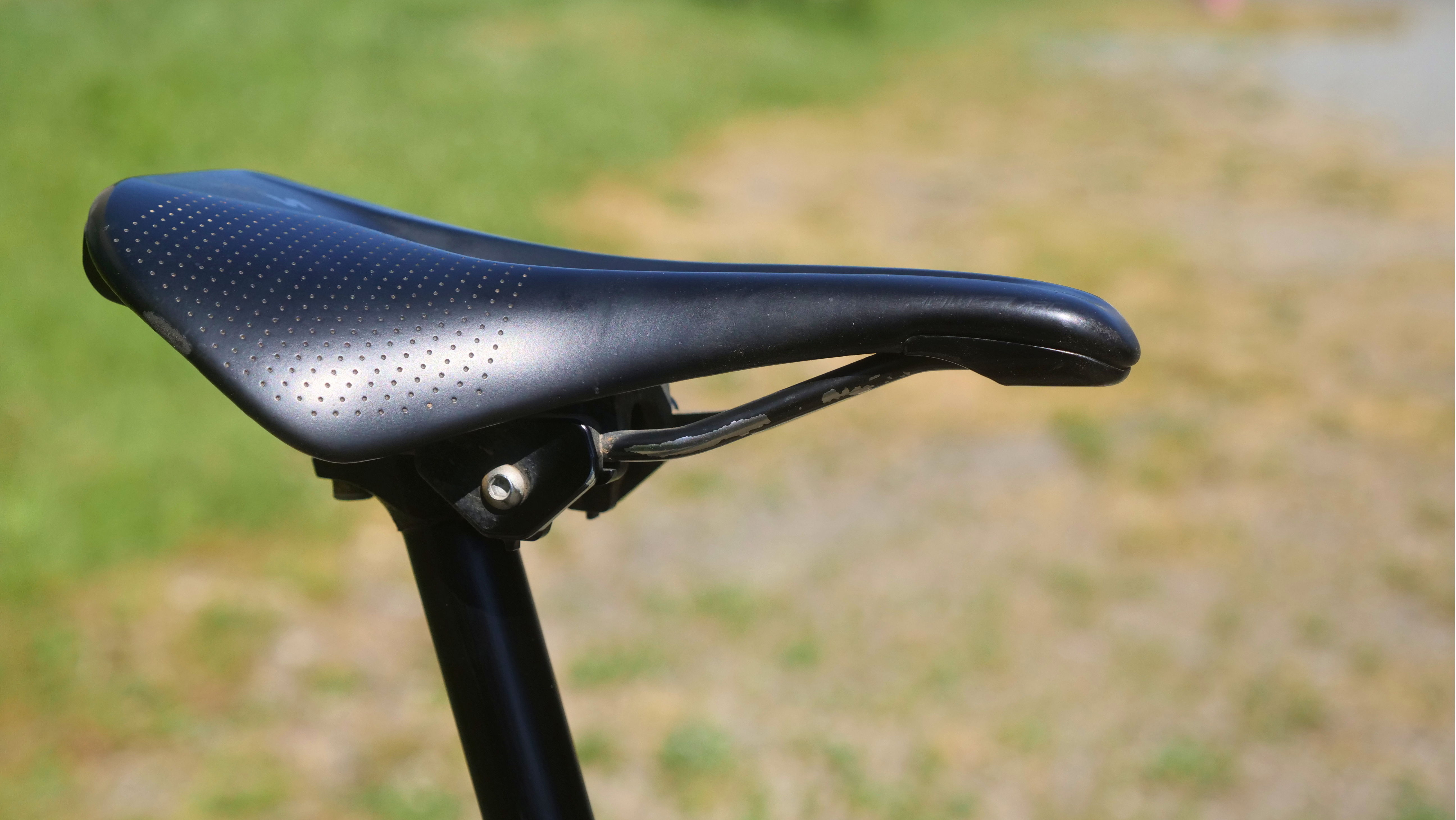 Close-up of a bicycle saddle on a seat post.