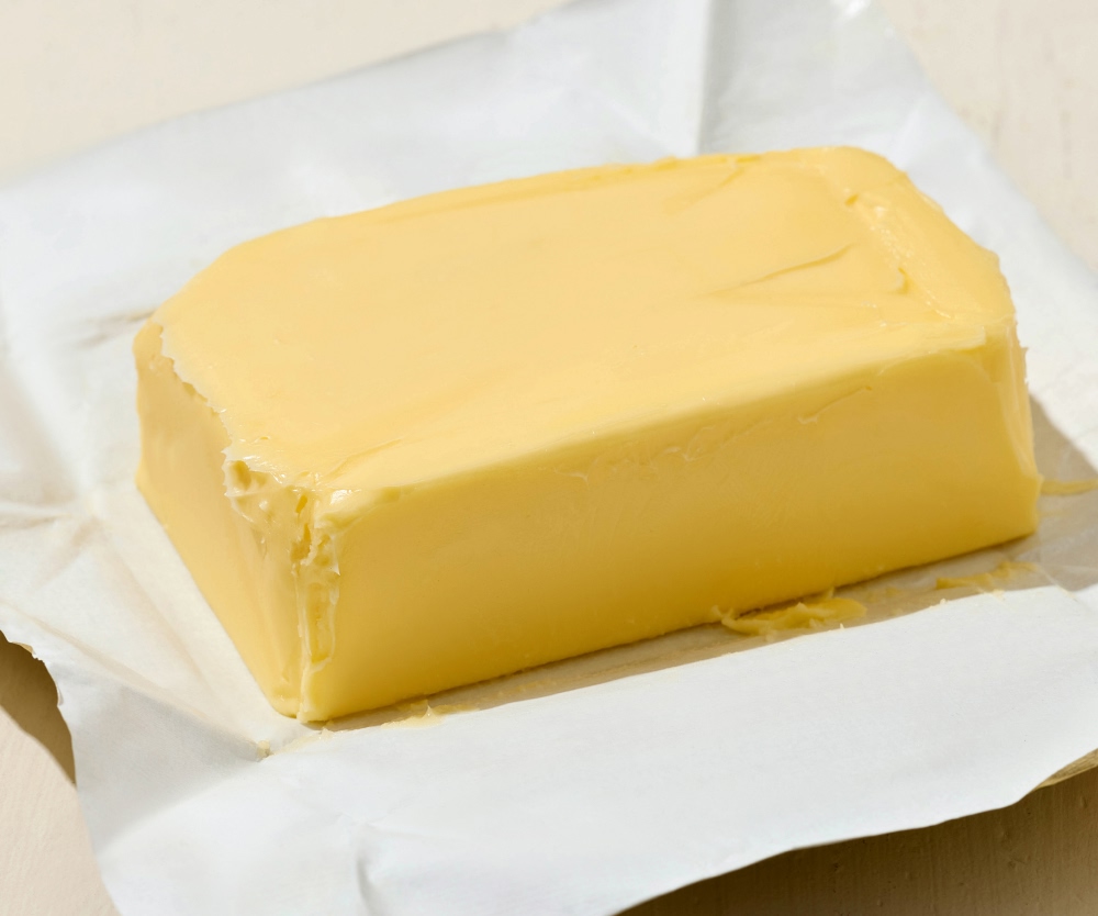 Block of butter wrapped in paper.