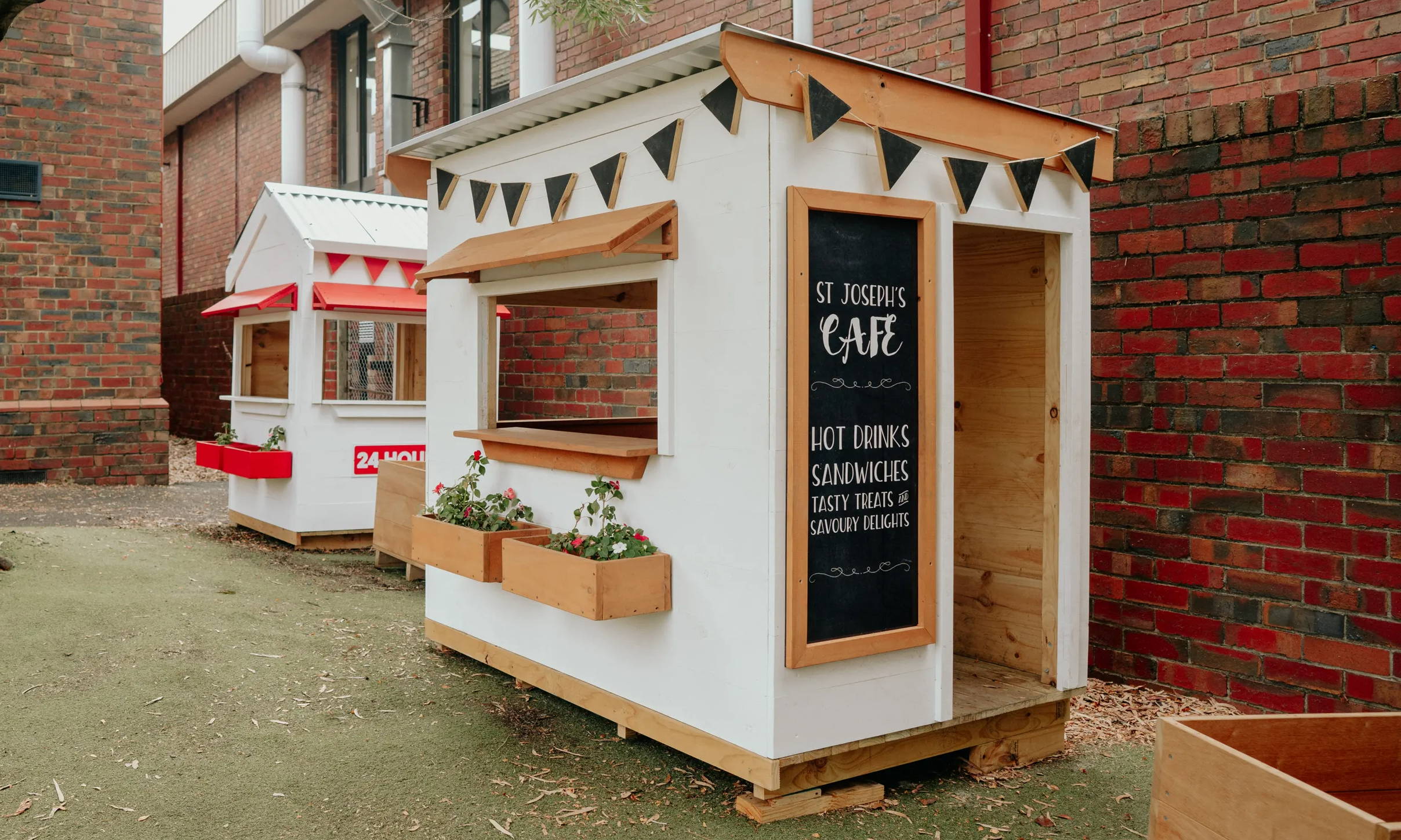 A cafe style cubby house with a flat roof 