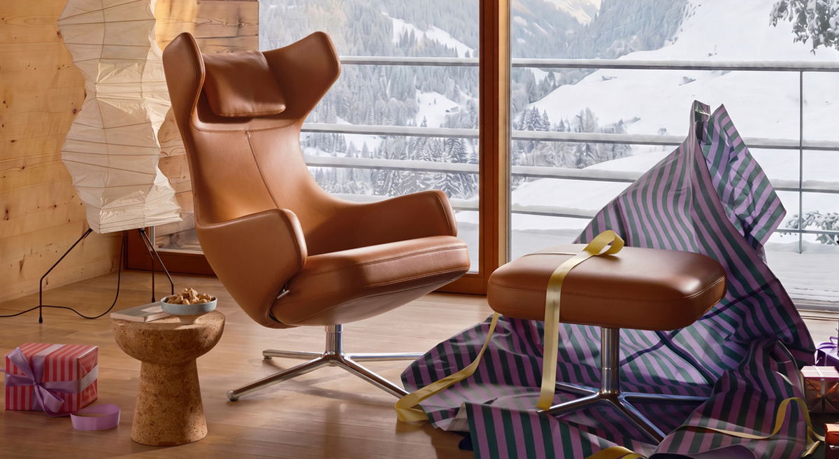 Cozy interior with a brown Grand Repos chair and snowy landscape outside.
