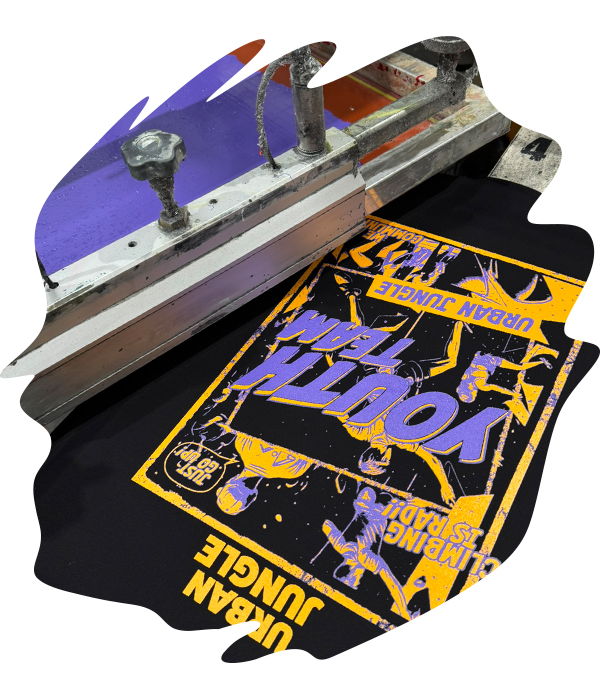 Screen printing press applying a vibrant purple and yellow Urban Jungle Youth Team graphic onto a black t-shirt