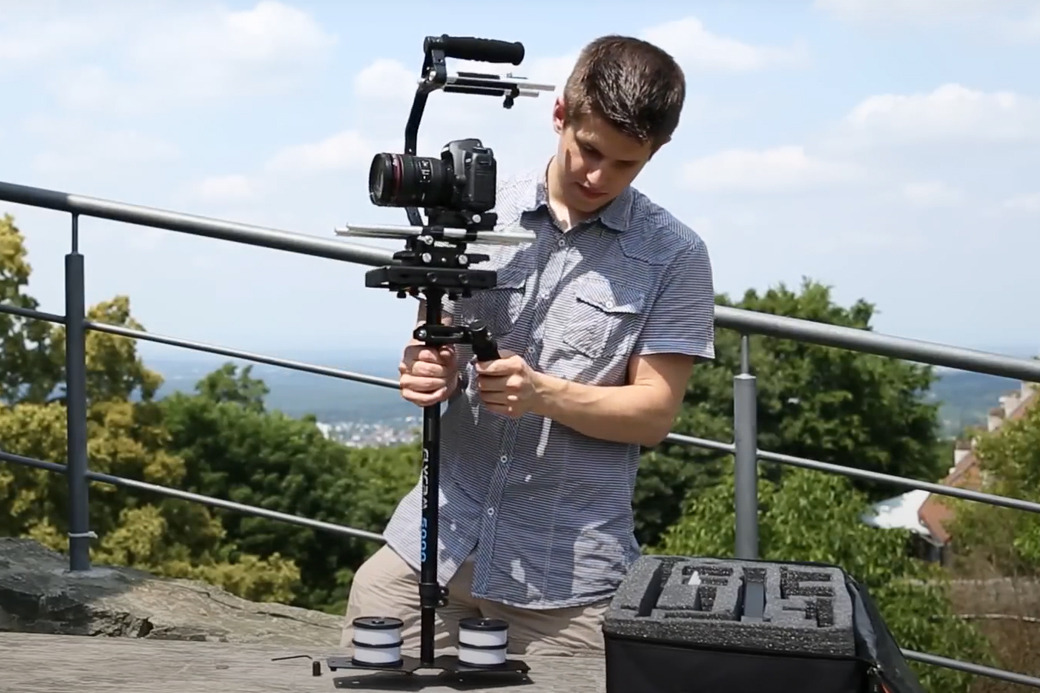 Operator filming handheld with the Flycam 5000 outdoors