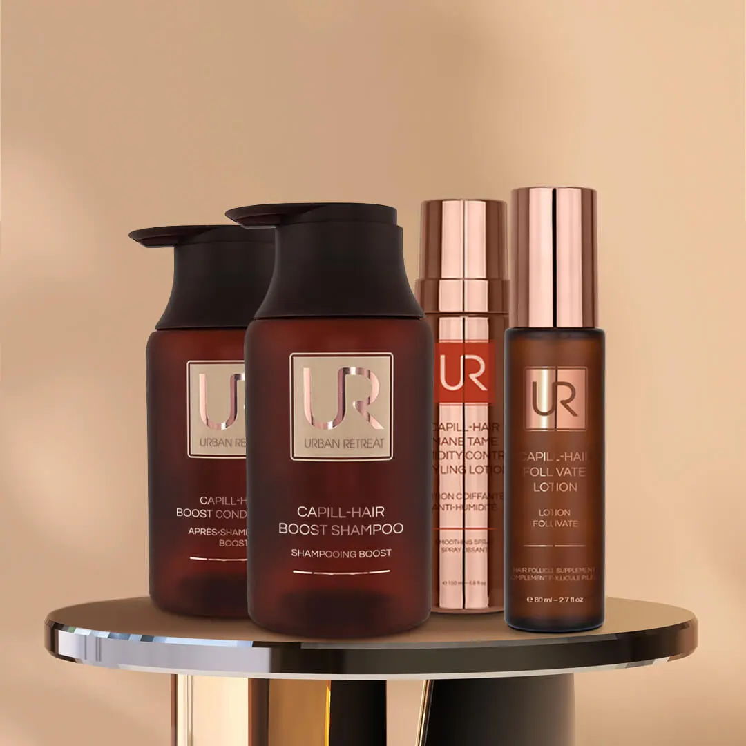 Urban Retreat Hair care products displayed on a round table with a neutral background.