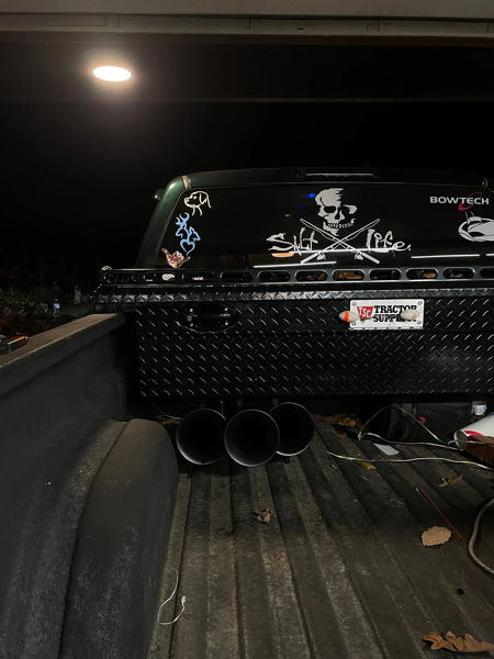 Three black train horns mounted under diamond-plate toolbox in Lukas' truck bed at night photo 3