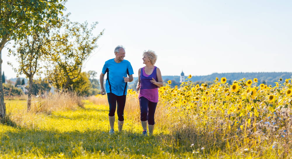 Elderly couple exercises together.