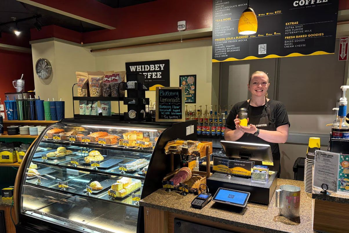 Barista serving a cup of coffee