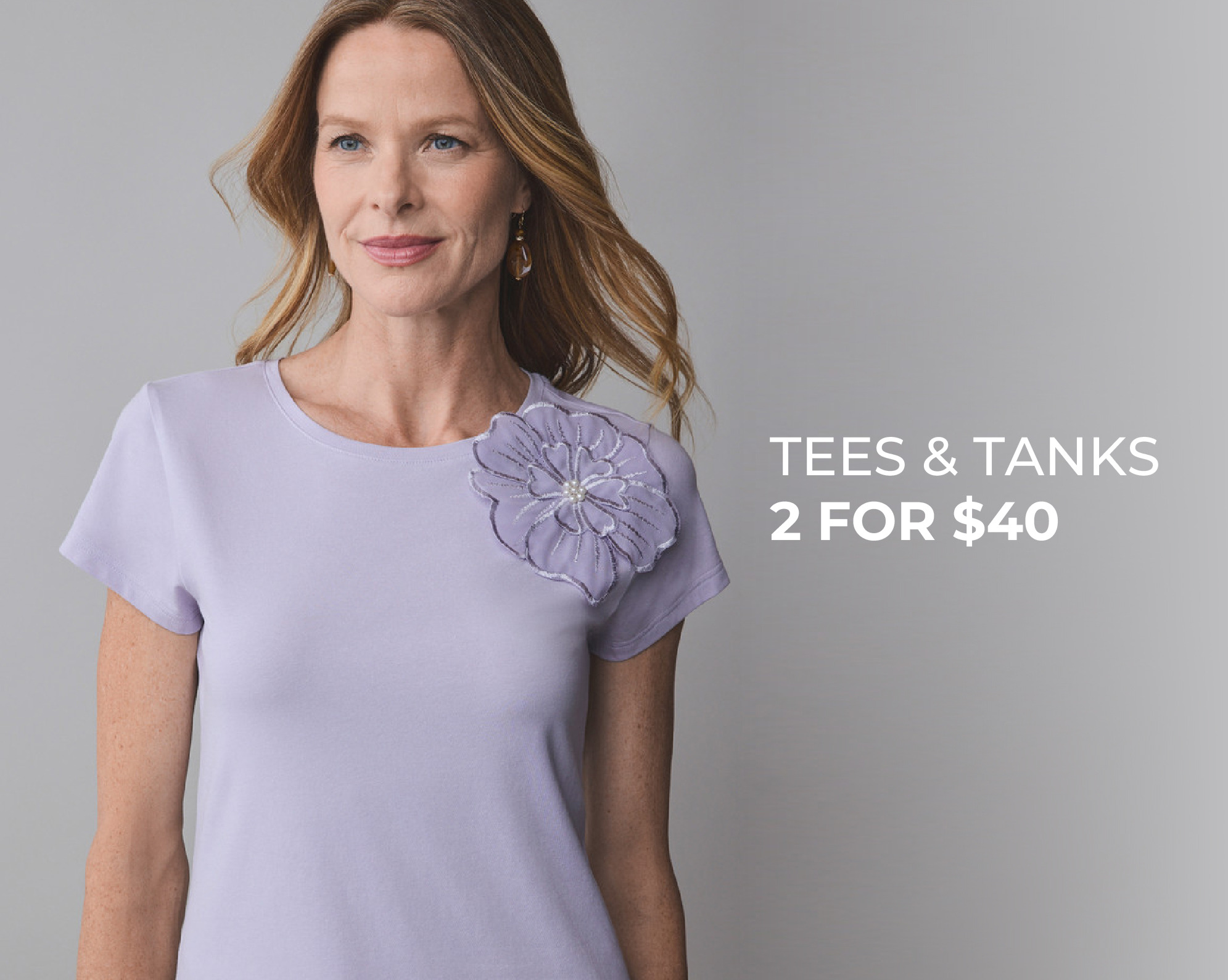 Woman in a lavender shirt promoting tees and tanks 2 for $40