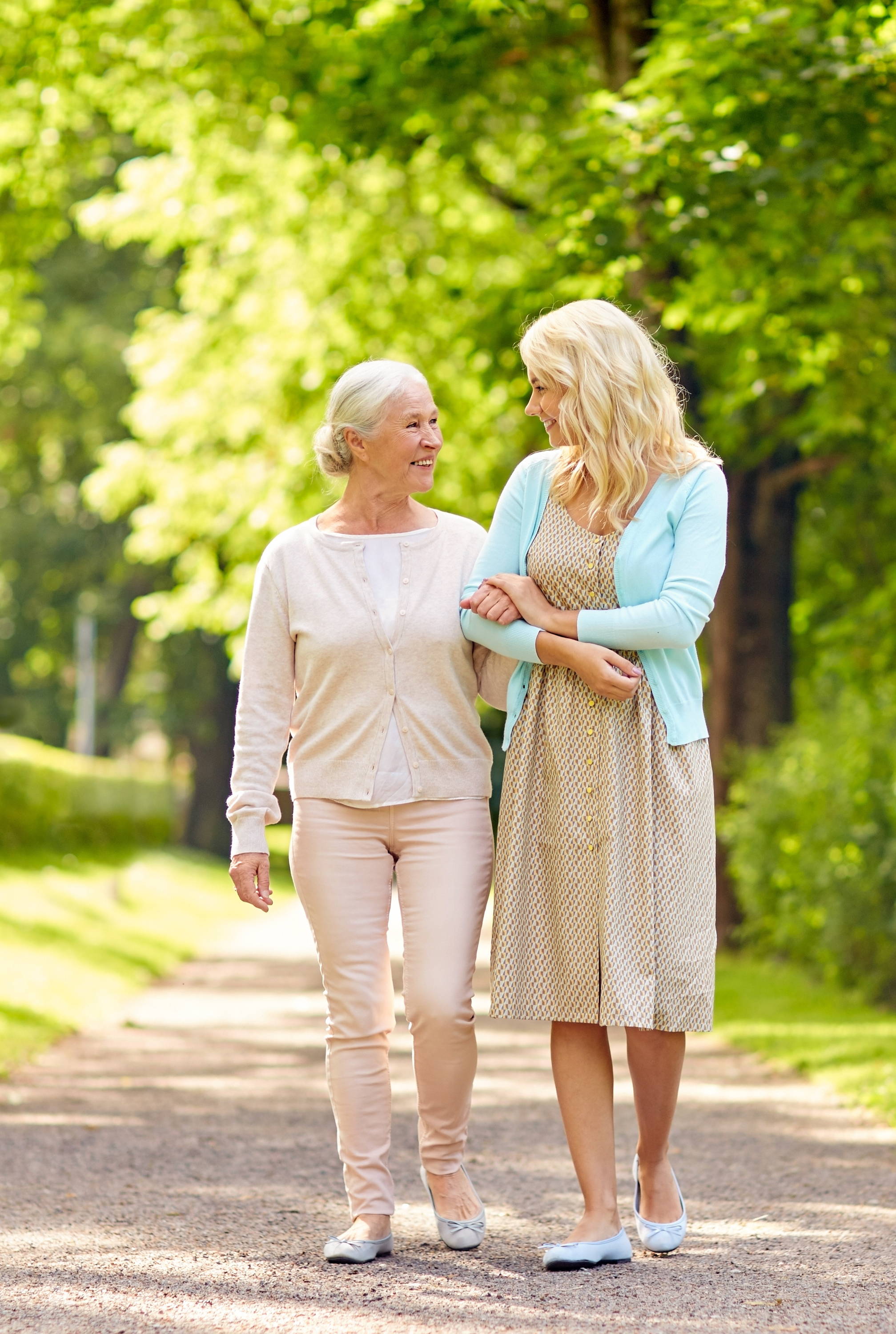 Happy Elderly woman walking with caretaker