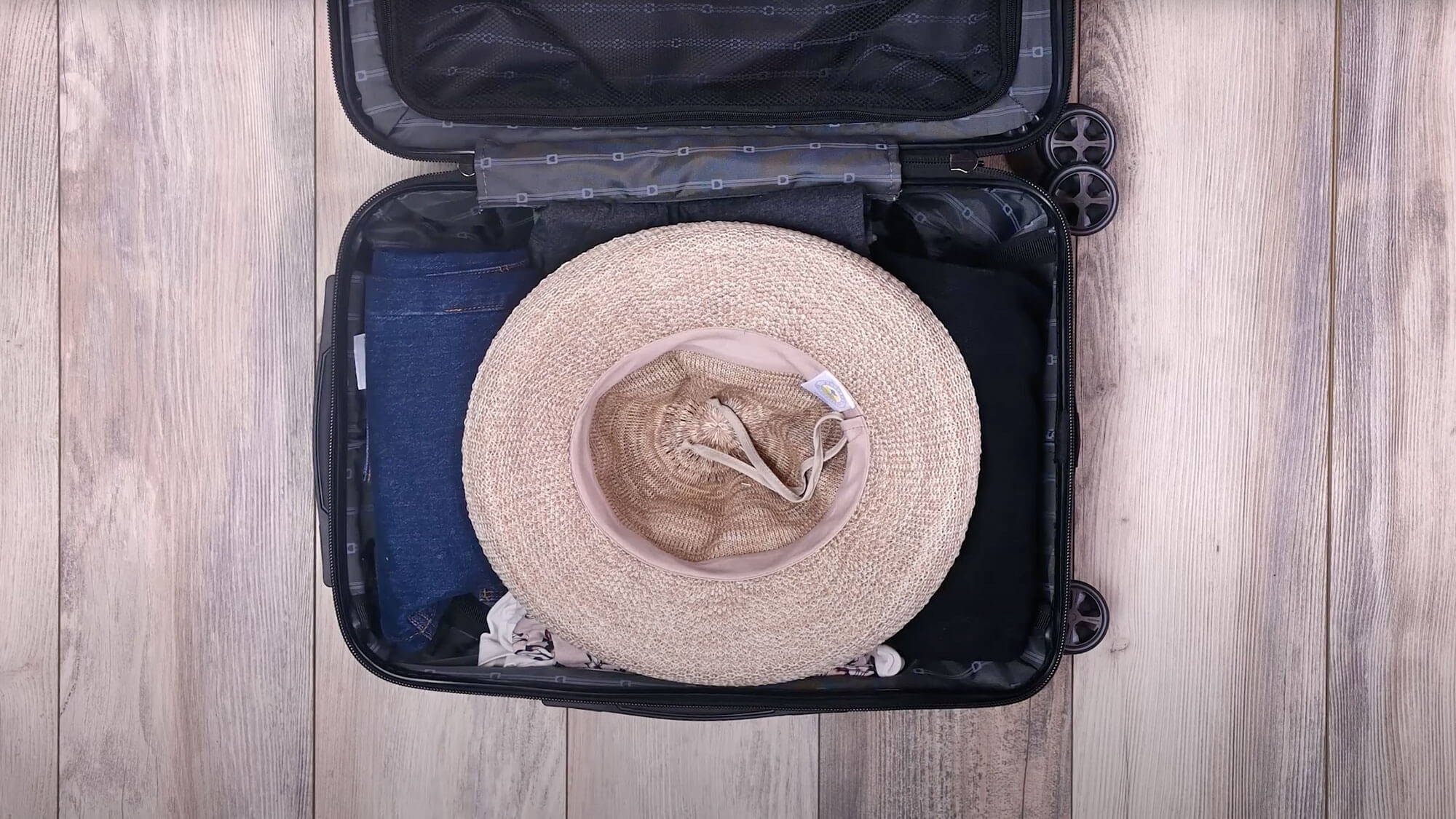 Stuffing a hat in luggage for travel