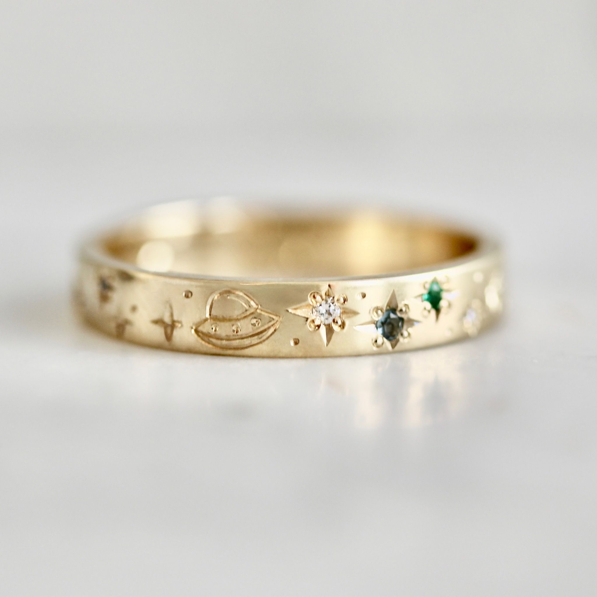 Hand-engraved wedding band with stars, star-set sapphires and diamonds, and UFO