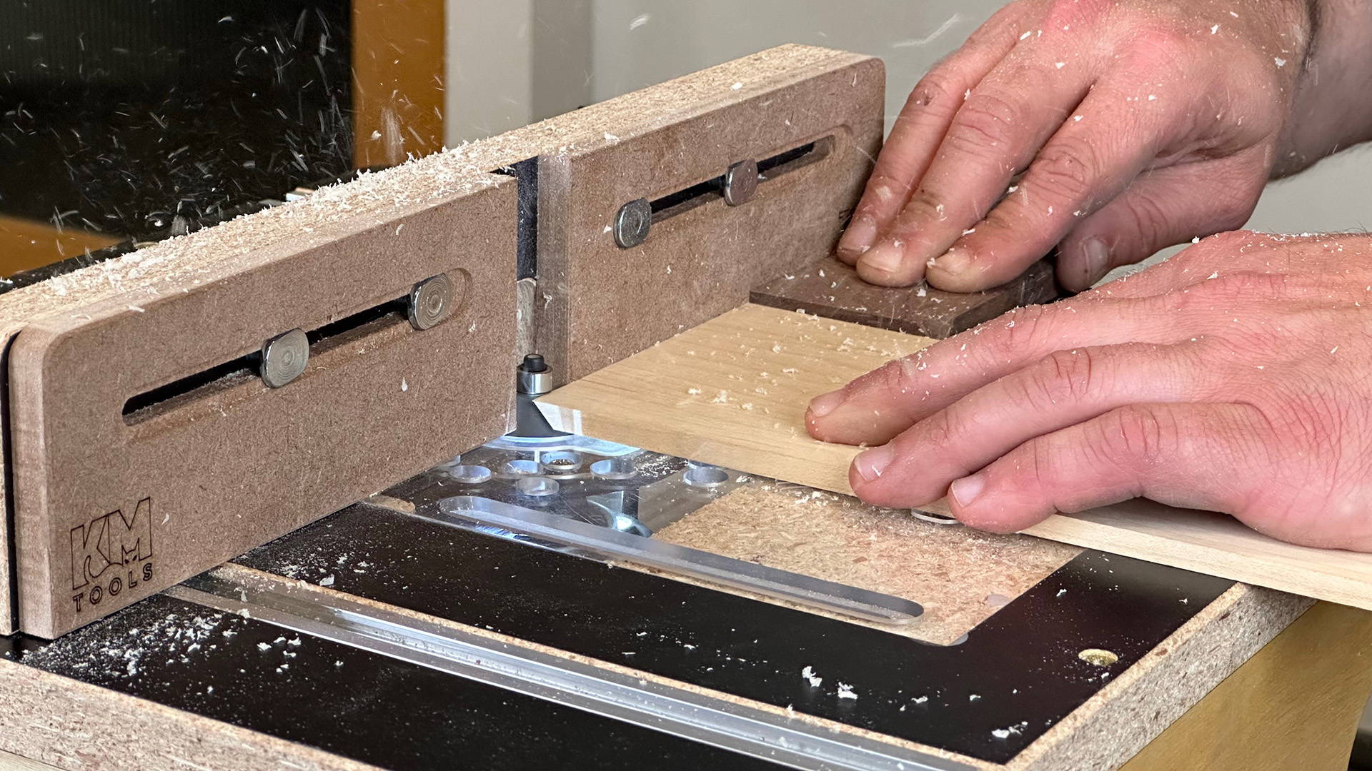 cutting a miter with backer board on benchtop router table