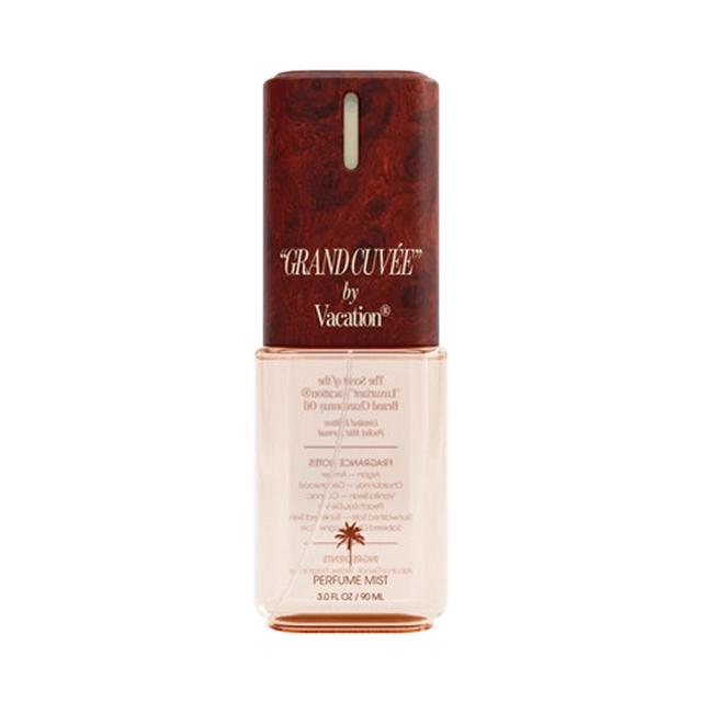 Bottle of tanning oil with a wooden cap and branding.