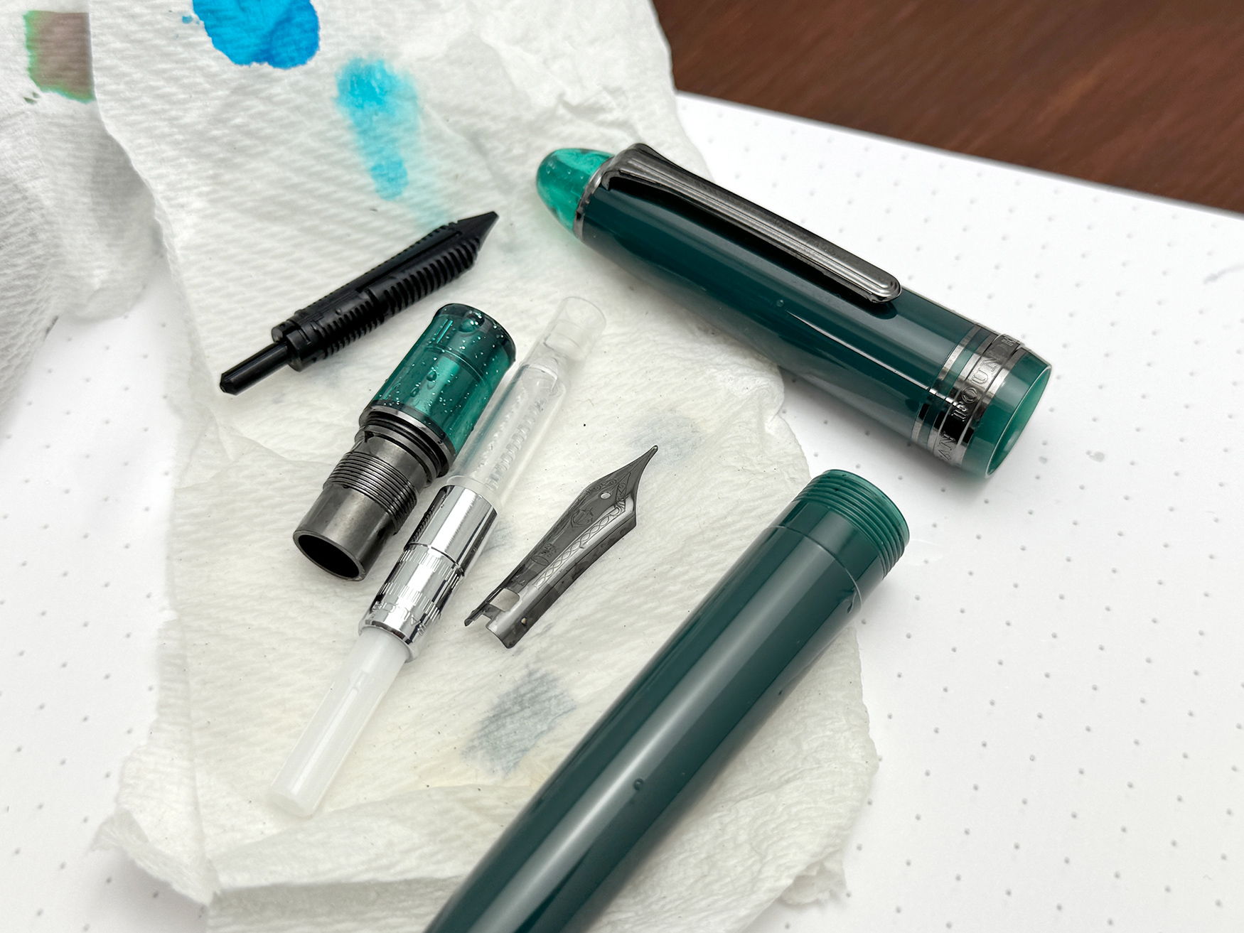 Sailor 1911 fountain pen parts drying on a paper towel