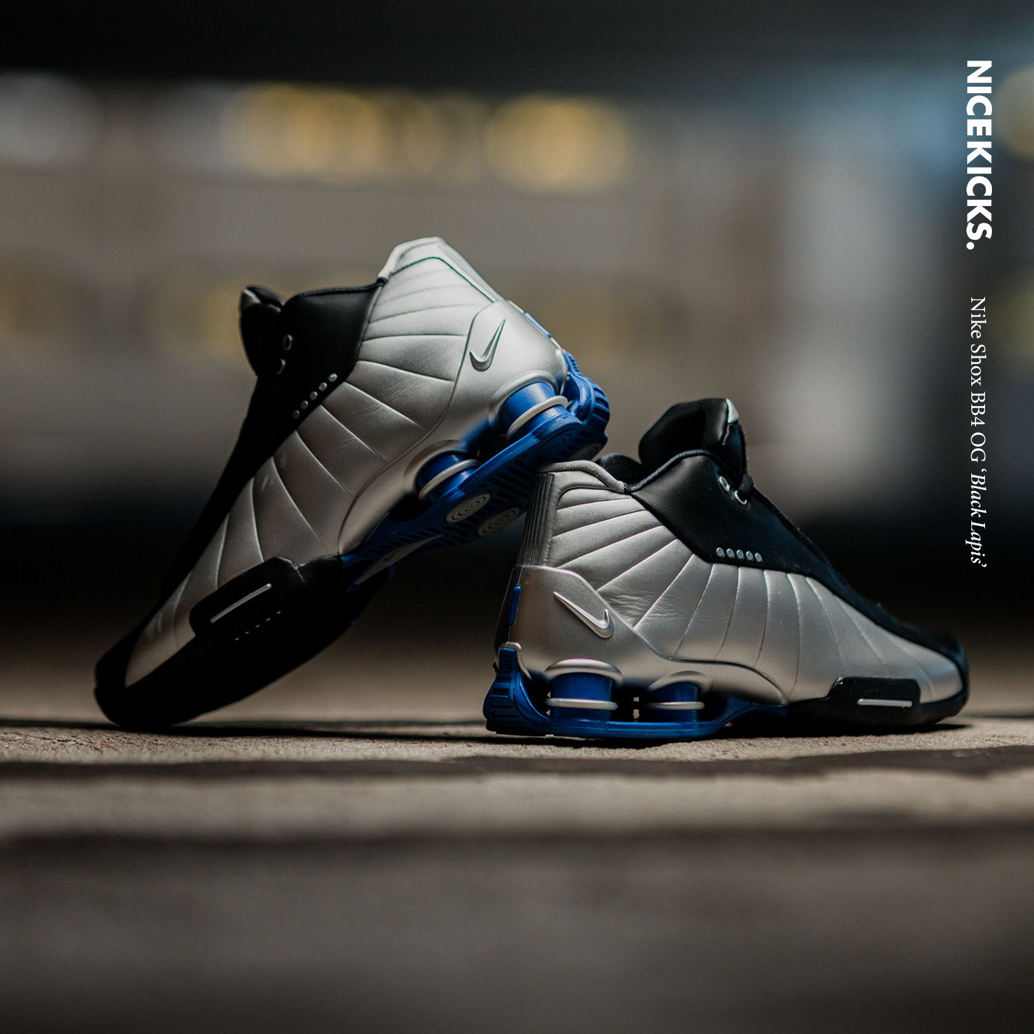 A pair of Nike sneakers in black and silver with blue accents.