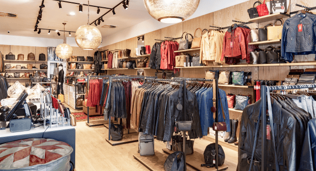 Clothing store interior displaying various jackets and leather apparel.