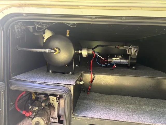 Storage compartment black air tank HornBlasters compressor pressure switch carpeted shelf wiring David's Winnebago Adventurer 35F Conductor's Special 232 gallery photo 3