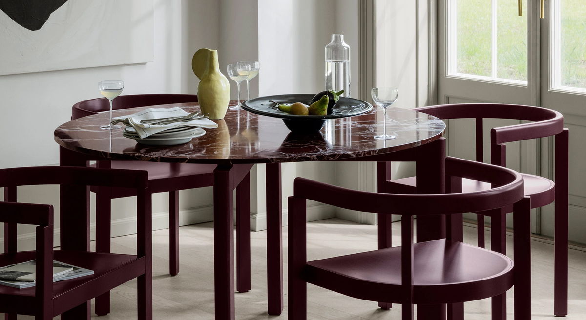 Close-up of a marble table with plates and a chair.