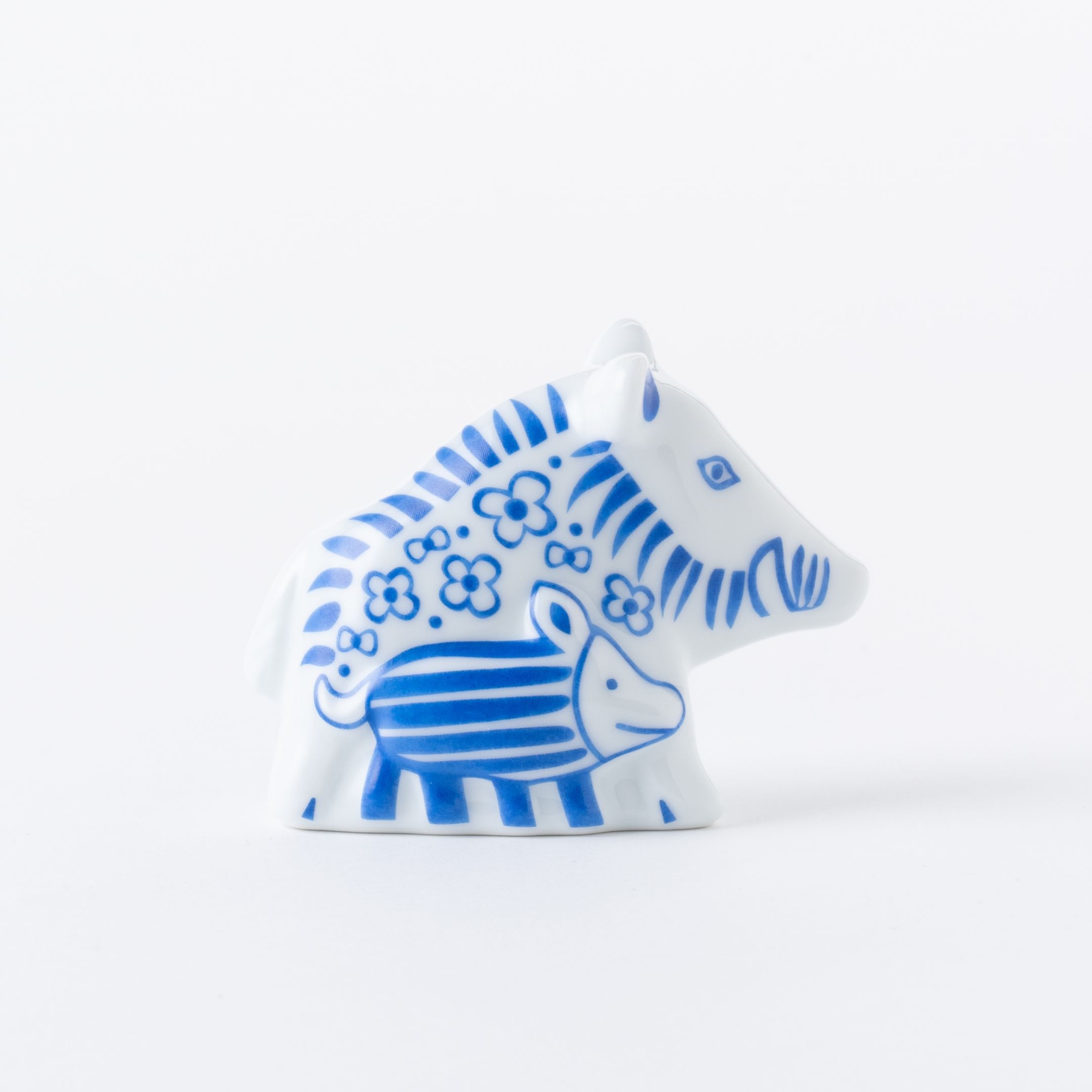 Ceramic figurine of a stylized animal with blue floral patterns.