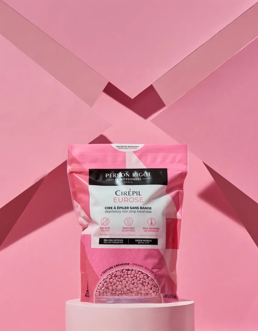Pink packaging on a pedestal against a pink background.
