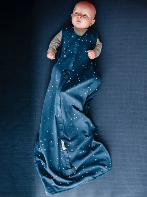 baby awake on cot sheet dressed in a tekapo starts 3 seasons Woolbabe sleeping bag