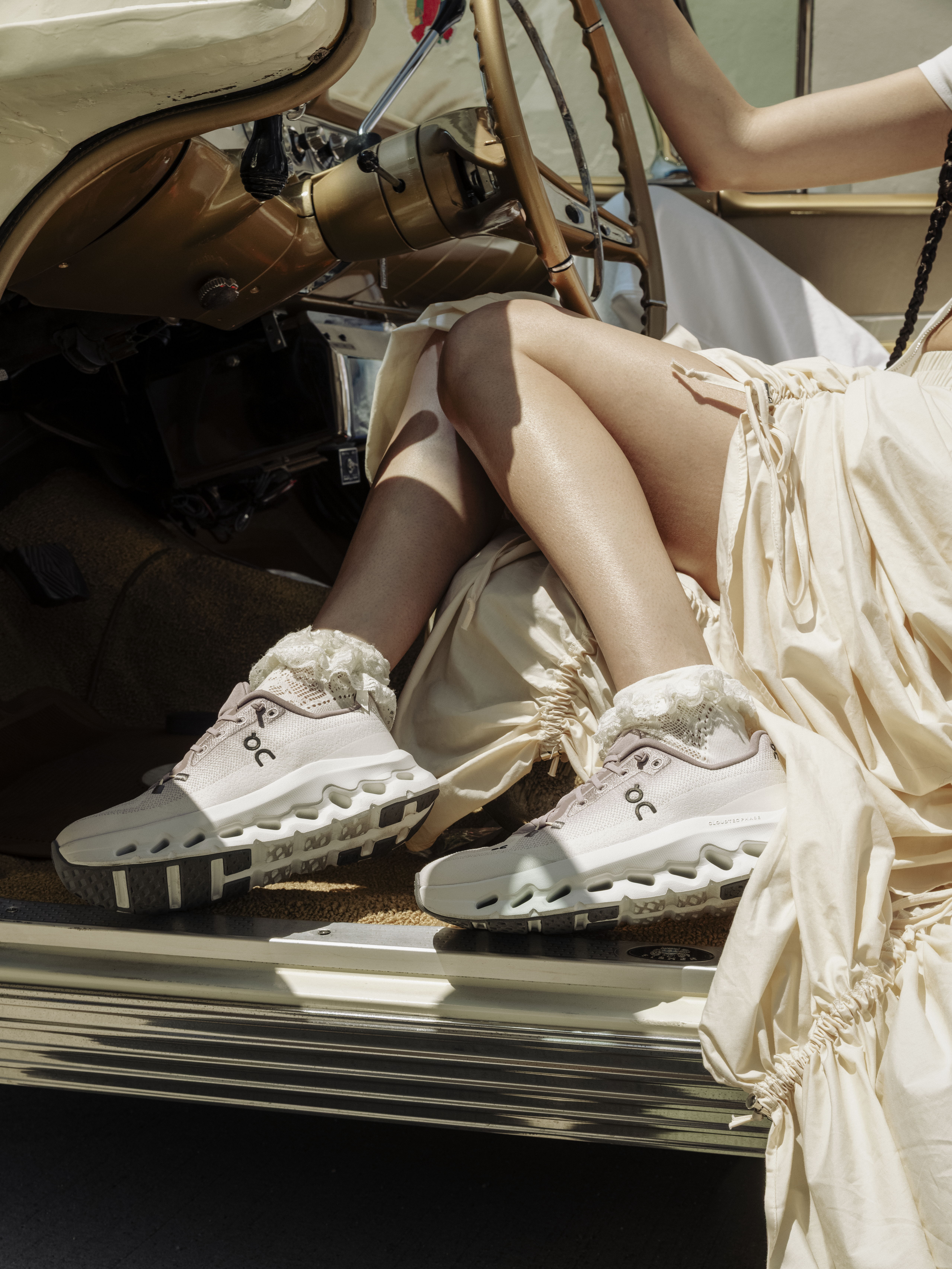 Person wearing stylish shoes inside a vintage car.