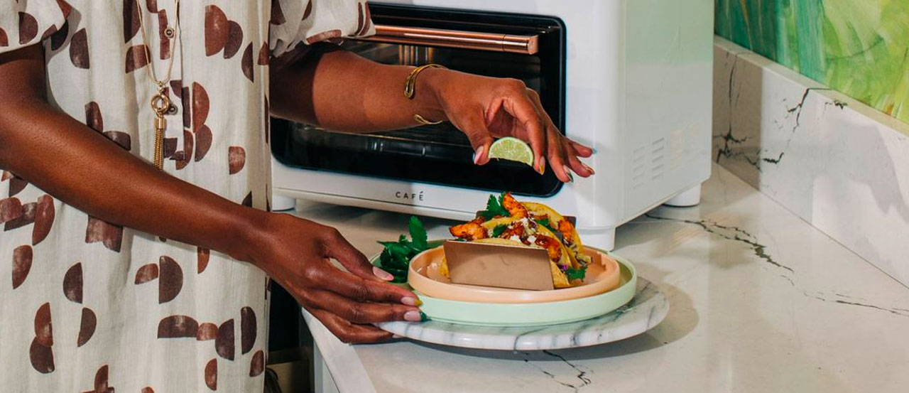 Woman with air fried shrimp tacos
