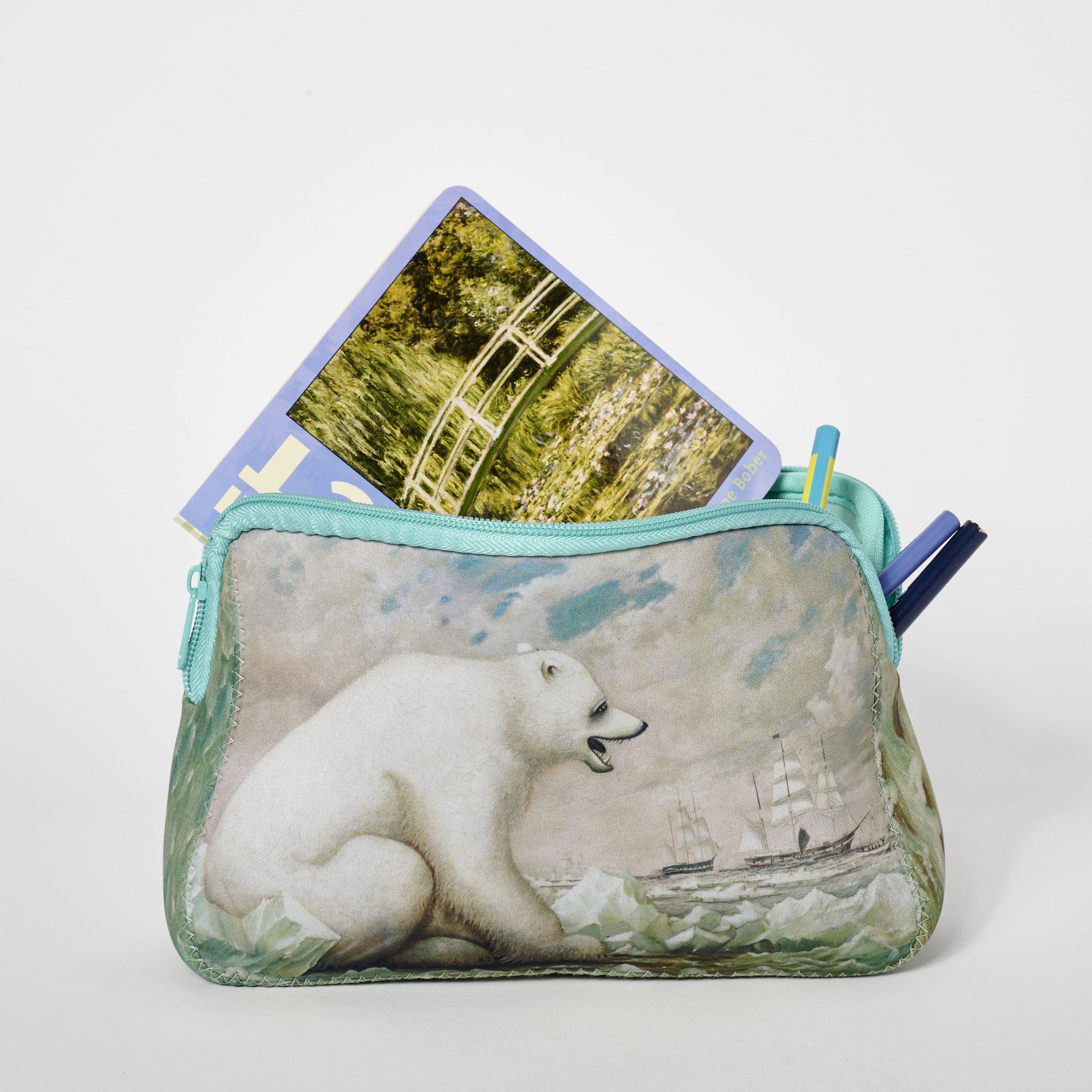 Polar bear pouch with postcards and a pen inside.