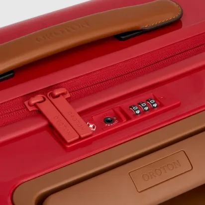 Close-up of a red suitcase with a brown handle and combination lock.