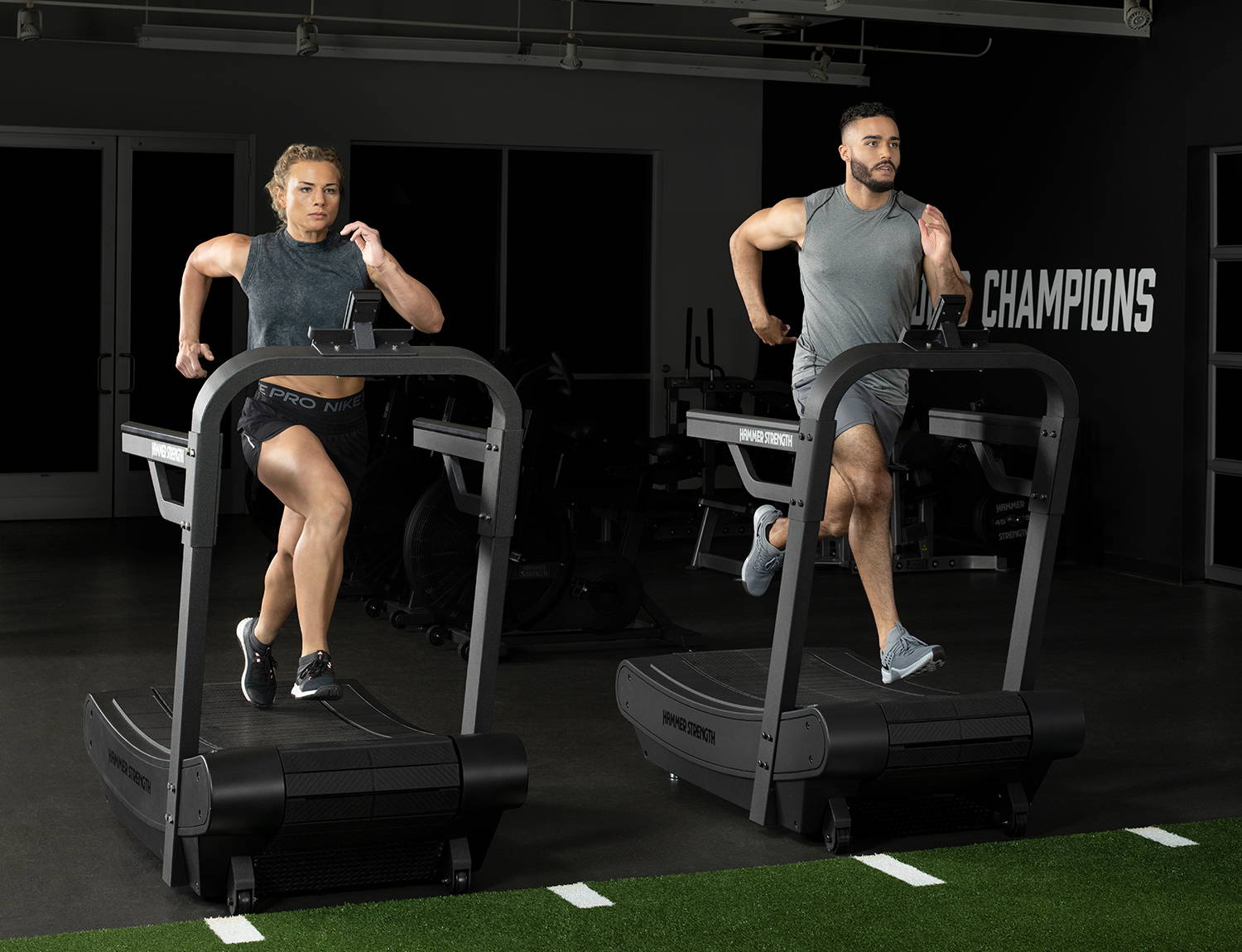 Two exrecisers running on Hammer Strength HD Tread
