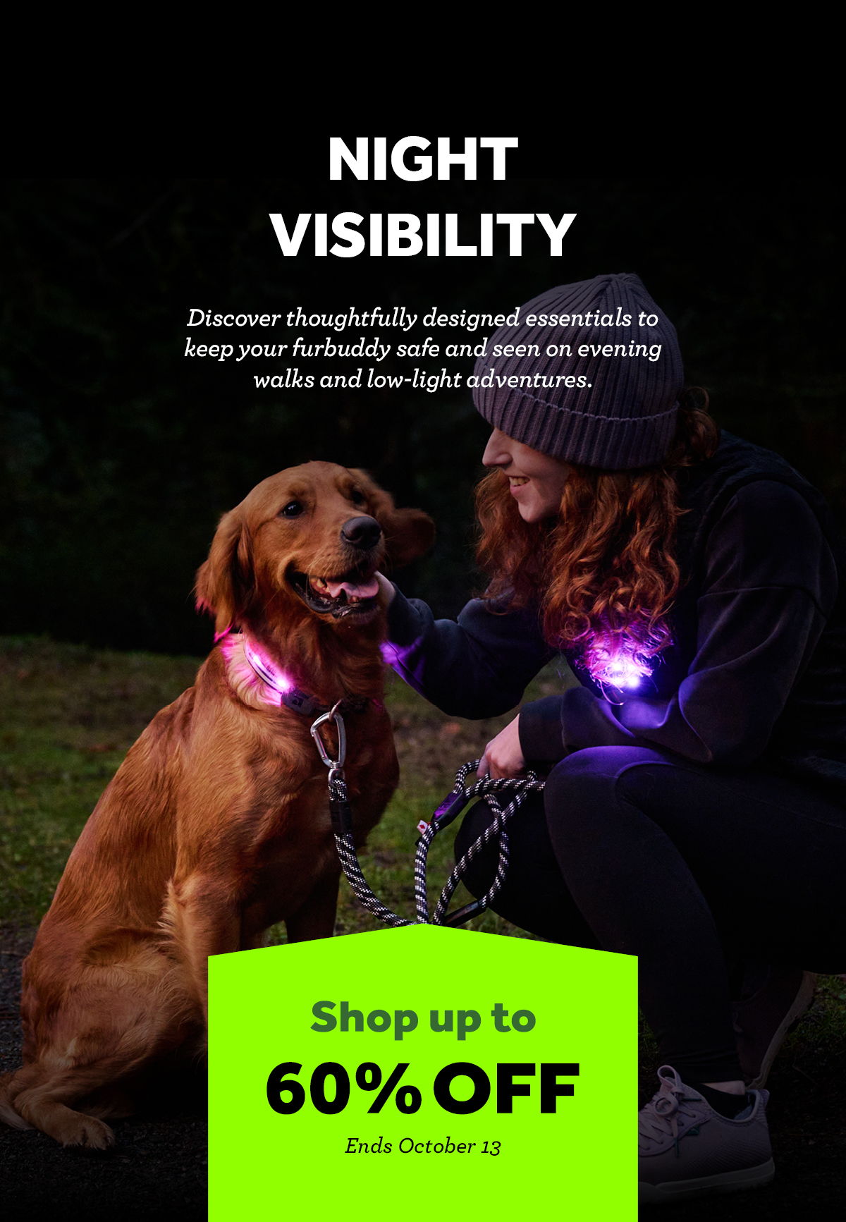 A woman with a dog wearing glowing collars in a dark setting.