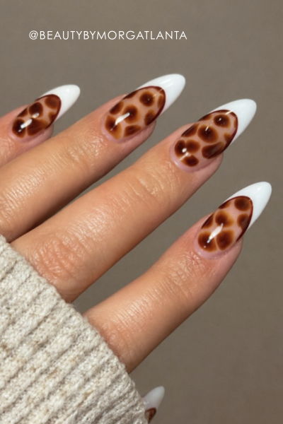Stylish long nails with tortie print and white tips.