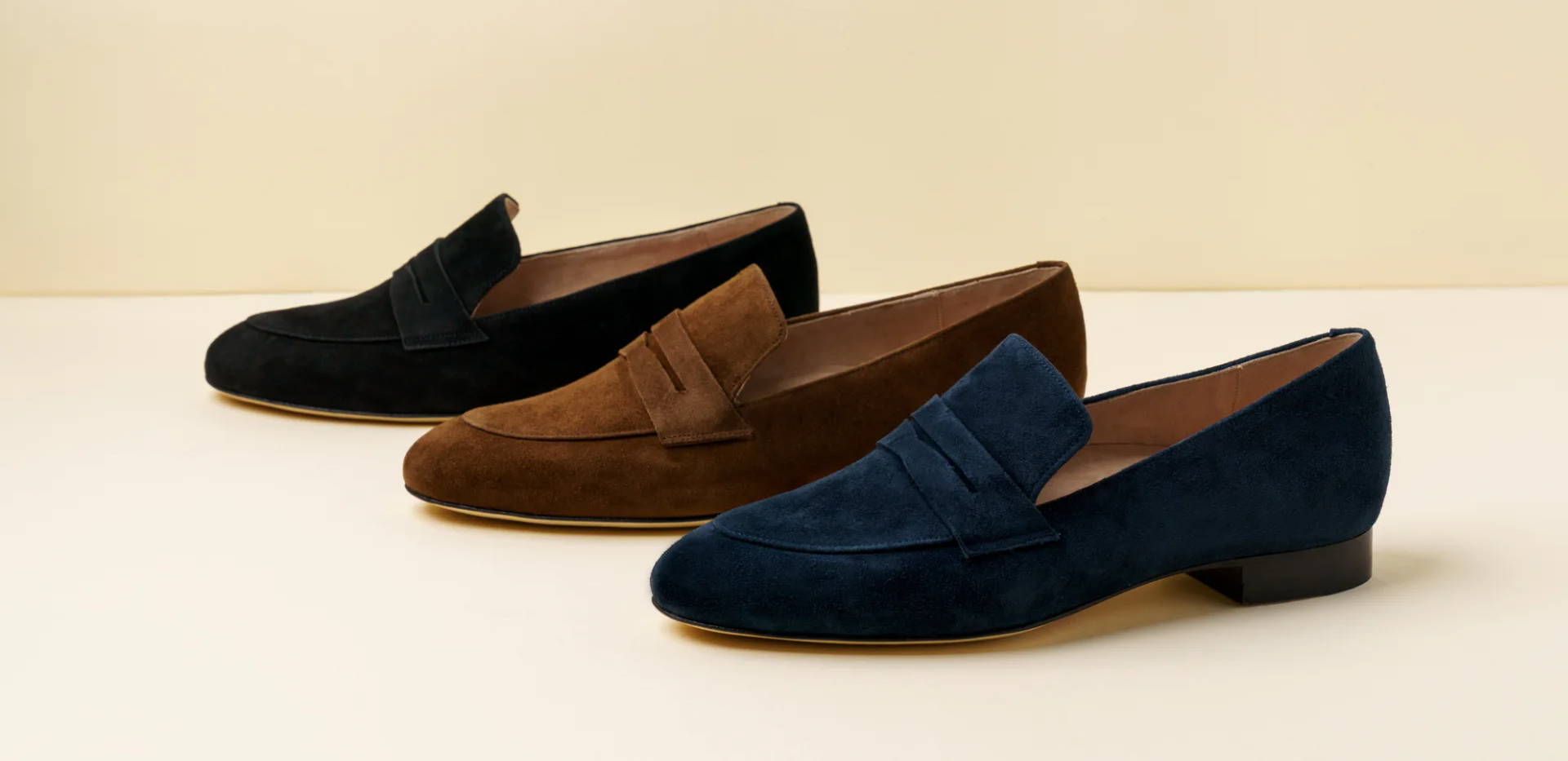 Three pairs of loafers in black, brown, and navy blue.